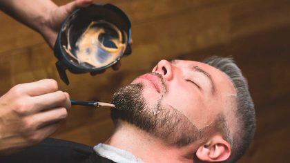 A barber giving a shave with a straight razor